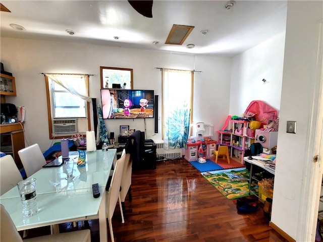 recreation room with cooling unit and dark hardwood / wood-style flooring