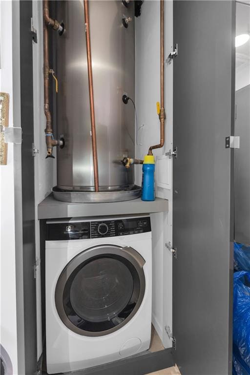 laundry room with gas water heater and washer / clothes dryer