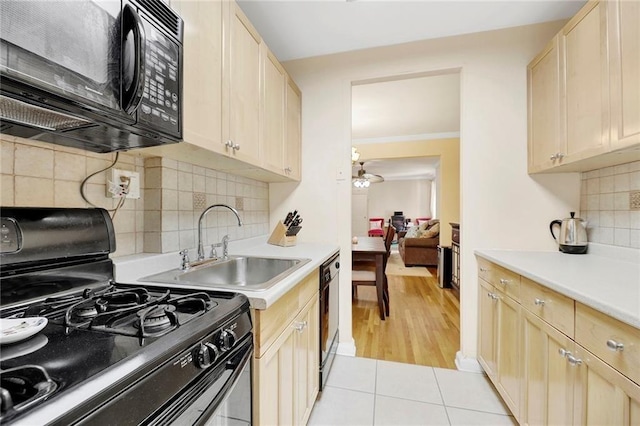 kitchen with black appliances, light brown cabinets, backsplash, crown molding, and light wood-type flooring