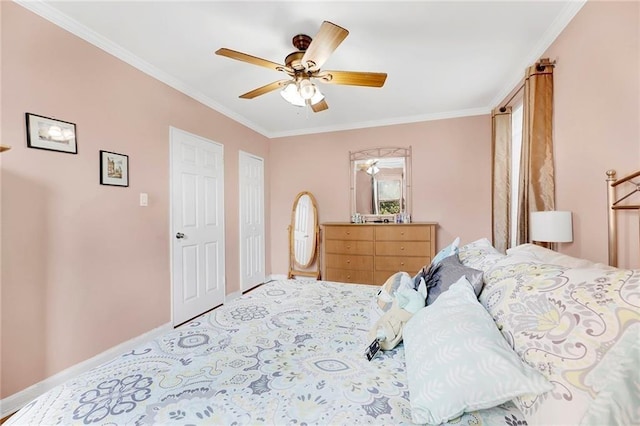 carpeted bedroom featuring multiple closets, ceiling fan, and crown molding