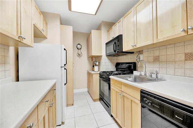 kitchen with black appliances, backsplash, light tile patterned floors, light brown cabinetry, and sink