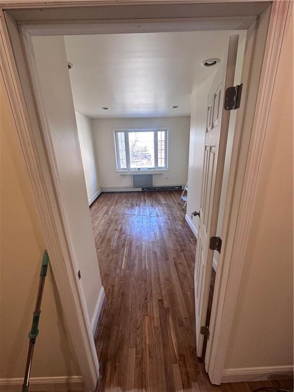 hallway with dark hardwood / wood-style floors