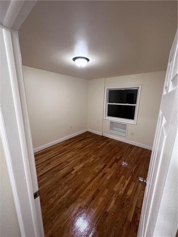 spare room featuring dark hardwood / wood-style flooring