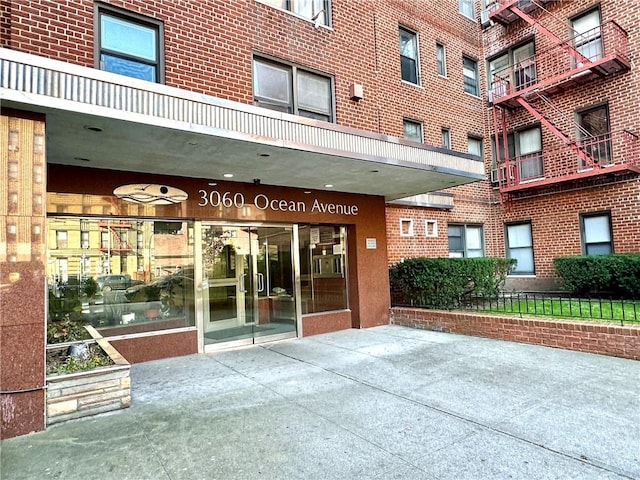 view of exterior entry featuring brick siding