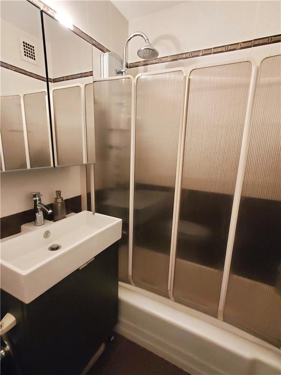 2475 W 16th St Unit 5A, Brooklyn, NY 11214 - full bath with vanity and combined bath / shower with glass door