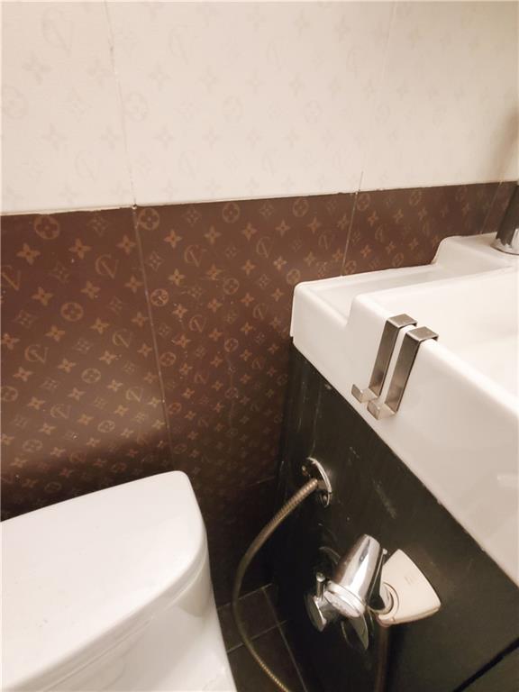 2475 W 16th St Unit 5A, Brooklyn, NY 11214 - bathroom view of wallpapered walls and toilet