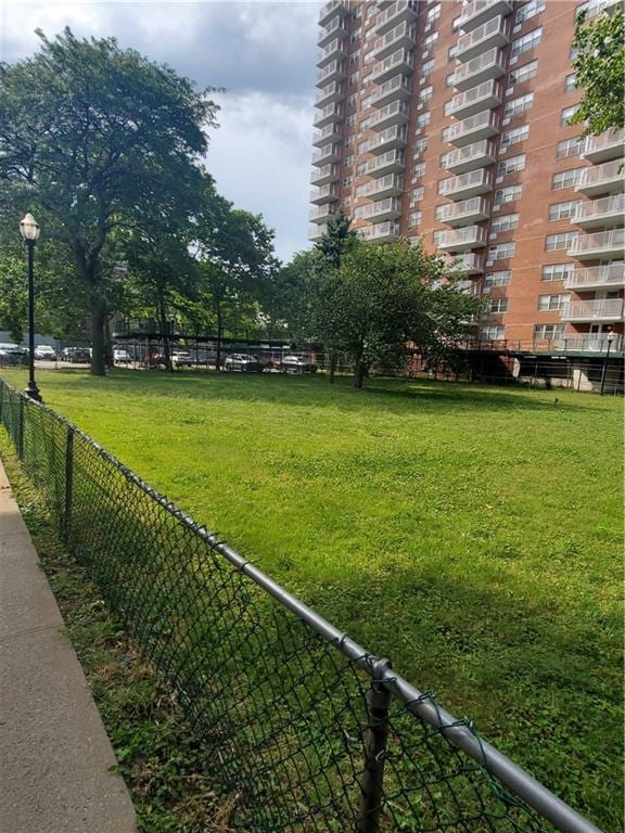 surrounding community with a lawn and fence