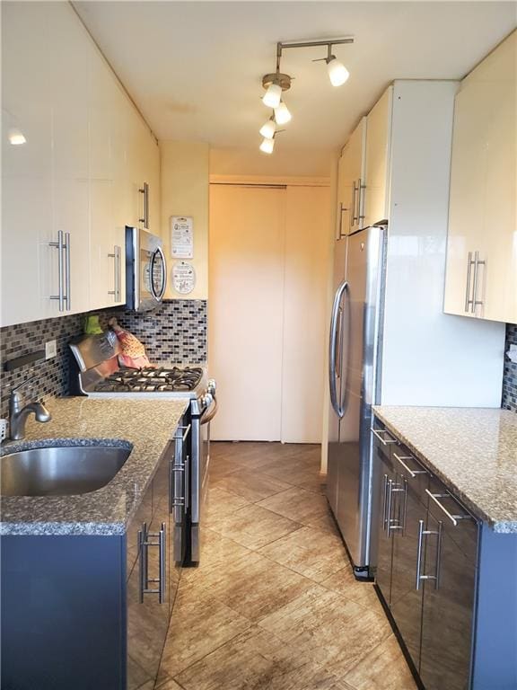 2475 W 16th St Unit 5A, Brooklyn, NY 11214 - kitchen with stainless steel appliances, a sink, decorative backsplash, and white cabinetry