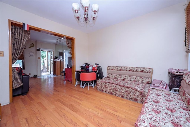 bedroom with a notable chandelier and wood finished floors