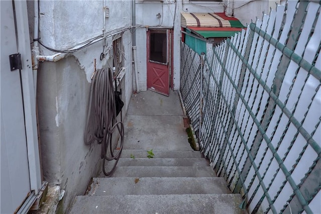 doorway to property featuring fence