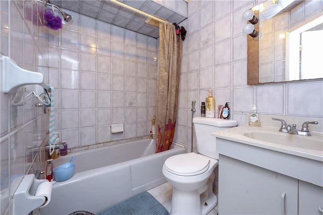 full bath featuring toilet, shower / tub combo with curtain, tile walls, and vanity