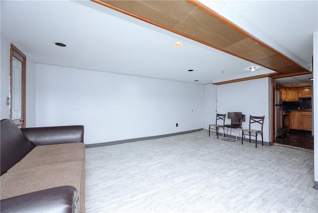 living area featuring light wood finished floors and baseboards