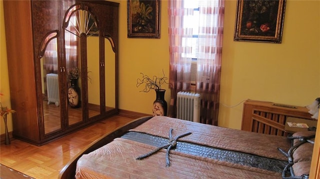 bedroom with radiator heating unit and baseboards