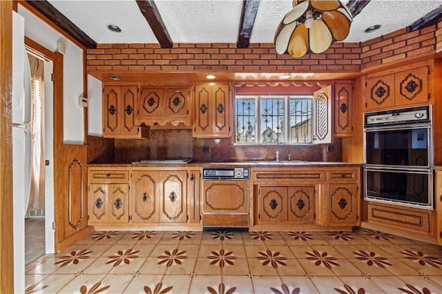 kitchen featuring beamed ceiling, dishwasher, a textured ceiling, and multiple ovens