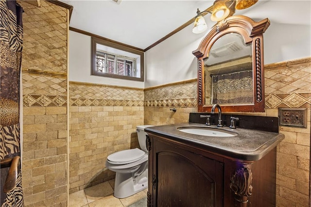 bathroom with tile walls, wainscoting, vanity, and toilet