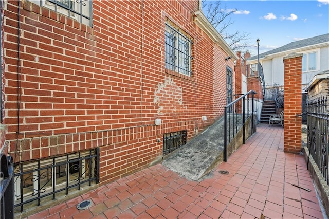 view of side of home with brick siding