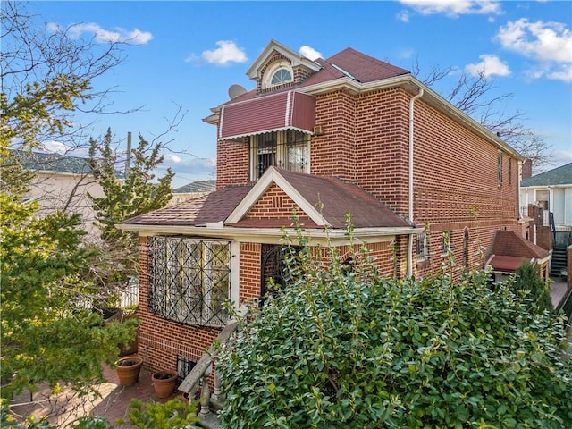 view of side of property with brick siding