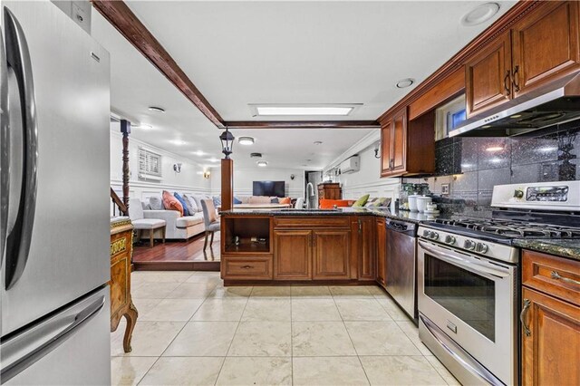 kitchen with sink, tasteful backsplash, dark stone countertops, appliances with stainless steel finishes, and ornamental molding