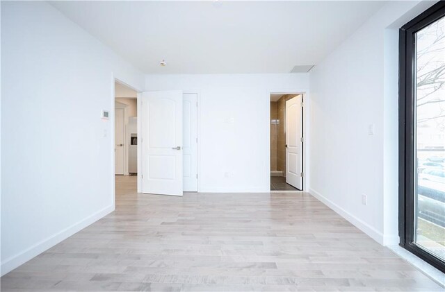 unfurnished room with light wood-type flooring