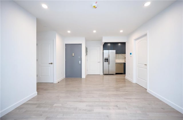 interior space featuring recessed lighting, light wood-type flooring, and baseboards