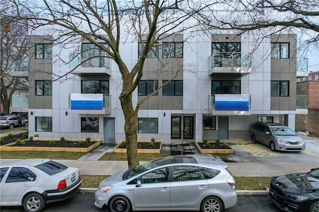 view of building exterior with uncovered parking