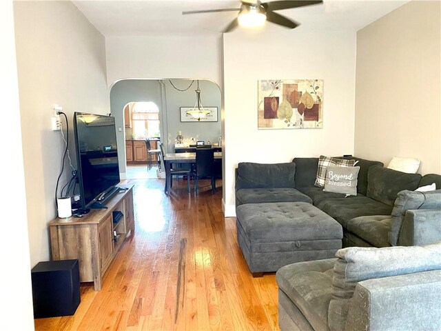 living room featuring ceiling fan and light hardwood / wood-style floors