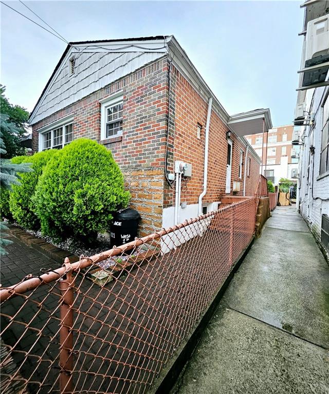 view of side of home featuring brick siding