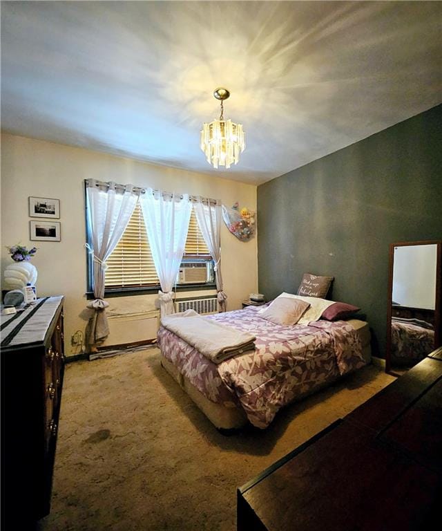 bedroom with an inviting chandelier and carpet