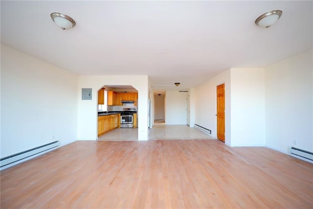 unfurnished living room with light hardwood / wood-style flooring and a baseboard radiator