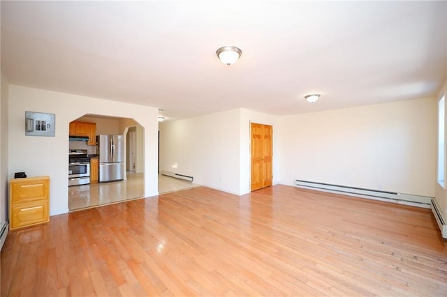 unfurnished living room with light wood-type flooring and baseboard heating