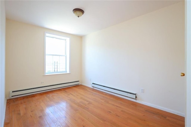 spare room with light hardwood / wood-style flooring and a baseboard heating unit