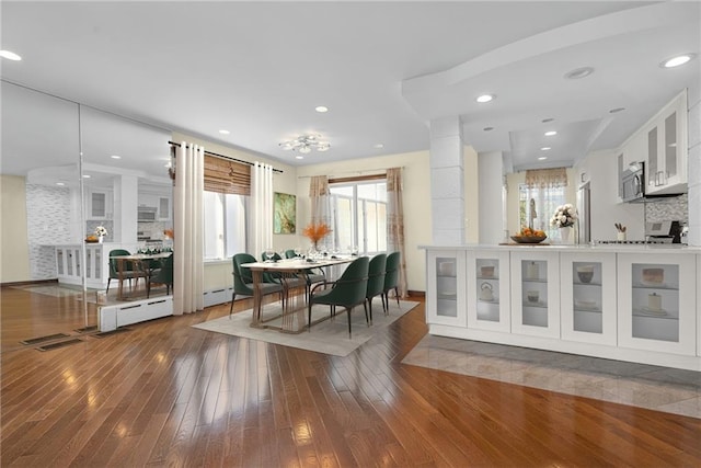 dining area with hardwood / wood-style floors and recessed lighting