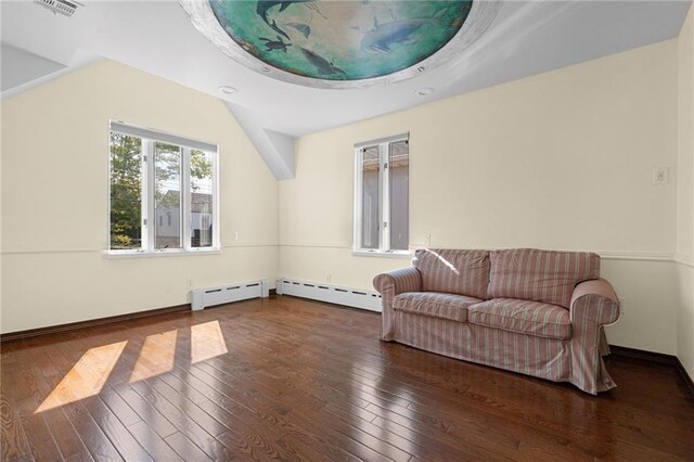 living area with a baseboard radiator, lofted ceiling, and dark hardwood / wood-style flooring