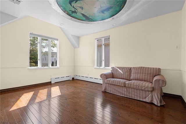 living area with lofted ceiling, wood-type flooring, and a baseboard heating unit