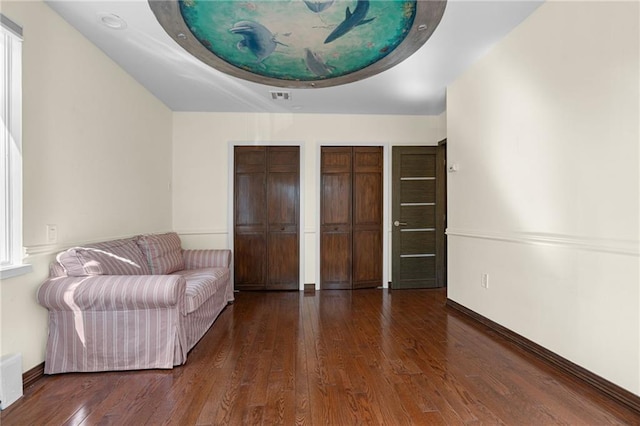 unfurnished room with dark wood-type flooring