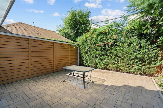 view of patio with outdoor dining space and fence