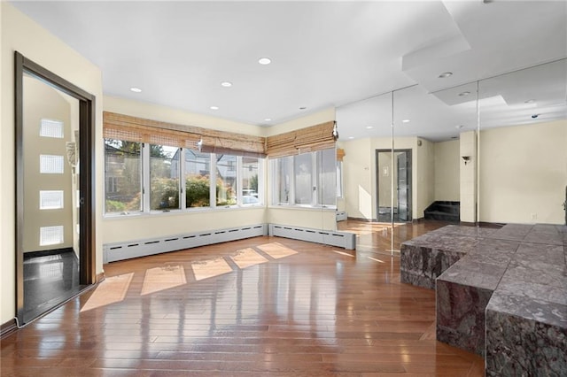 interior space featuring recessed lighting, stairway, and wood-type flooring