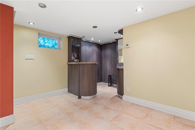 bar with light tile patterned floors, baseboards, and recessed lighting