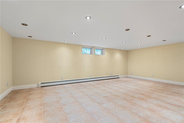 spare room with a baseboard radiator, light tile patterned floors, baseboards, and recessed lighting