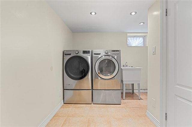 washroom with washer and clothes dryer, recessed lighting, laundry area, baseboards, and tile patterned floors