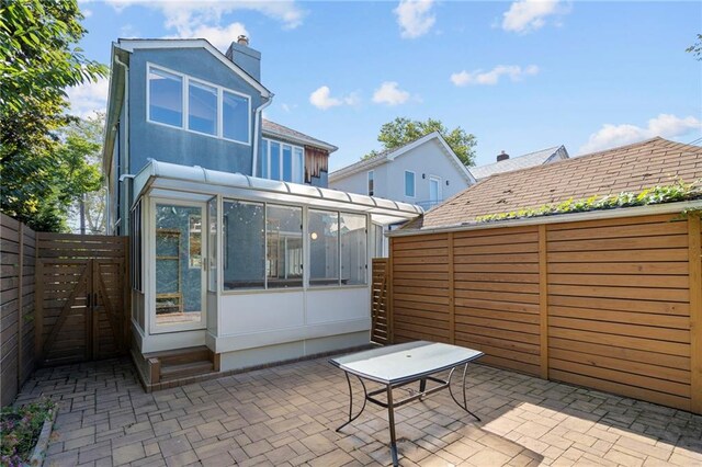 view of patio / terrace with a sunroom