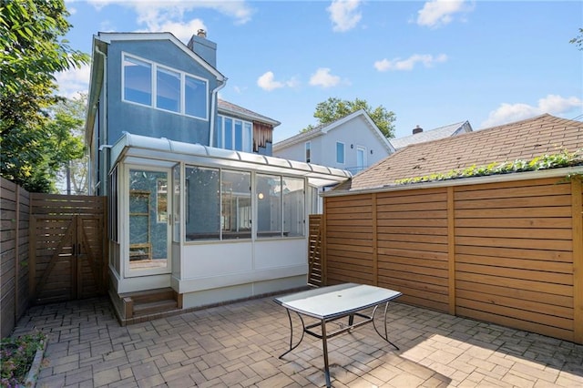 view of patio with a sunroom and a fenced backyard