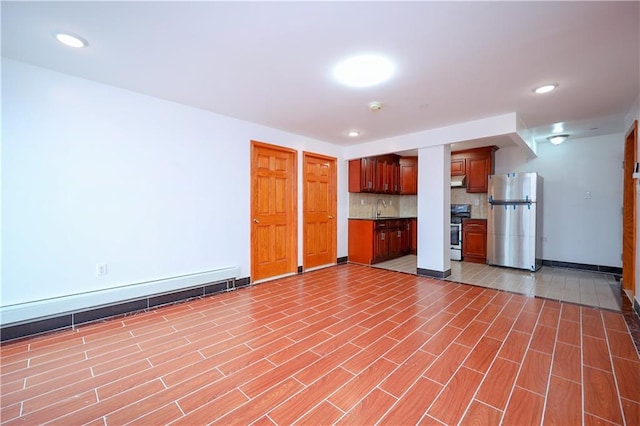 interior space featuring sink, stainless steel appliances, and tasteful backsplash