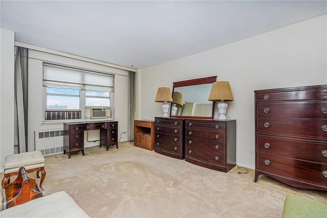 living area with light carpet, radiator heating unit, and cooling unit