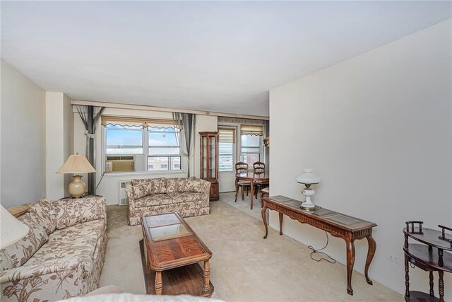 carpeted living room featuring cooling unit and radiator