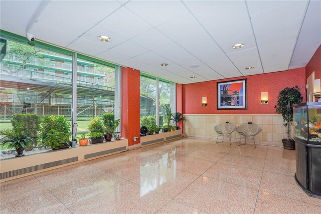 2630 Cropsey Ave Unit 9K, Brooklyn, NY 11214 - community lobby with a security system, wainscoting, a wall of windows, and recessed lighting