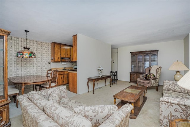 living room featuring light carpet and wallpapered walls