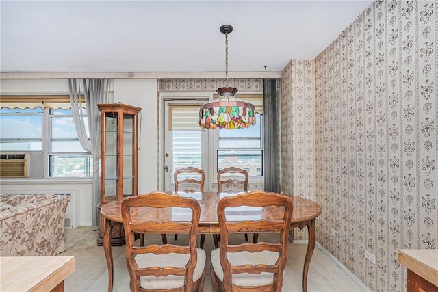 dining area with wallpapered walls and light colored carpet