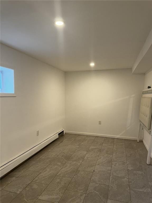 below grade area with baseboards, recessed lighting, and a baseboard radiator