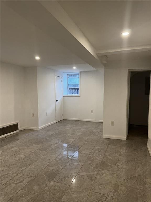 finished below grade area with recessed lighting, visible vents, and baseboards